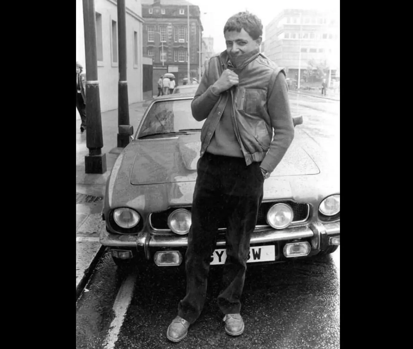 Rowan Atkinson with his Aston Martin V8, in Glasgow, Scotland - 1983.webp